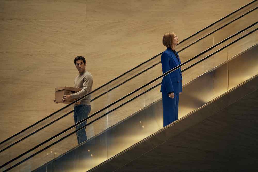 Ladies First. (L-R) Sacha Baron Cohen as Damien Sachs and Rosamund Pike as Alex Fox in Ladies First. Cr. Rob Youngson/Netflix © 2026.
