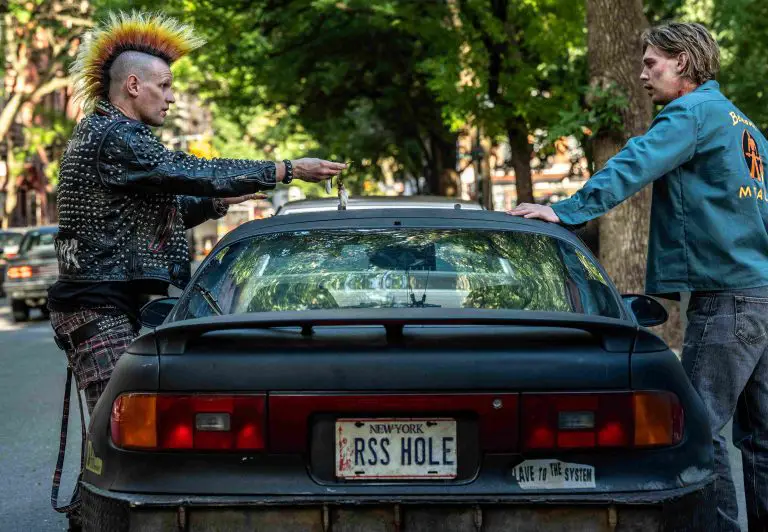 Russ (Matt Smith, left) hands over the keys to Hank (Austin Butler, right) in Columbia Pictures CAUGHT STEALING. photo by: Niko Tavernise - © 2025 CTMG, Inc. All Rights Reserved. **ALL IMAGES ARE PROPERTY OF SONY PICTURES ENTERTAINMENT INC. FOR PROMOTIONAL USE ONLY. SALE, DUPLICATION OR TRANSFER OF THIS MATERIAL IS STRICTLY PROHIBITED.**