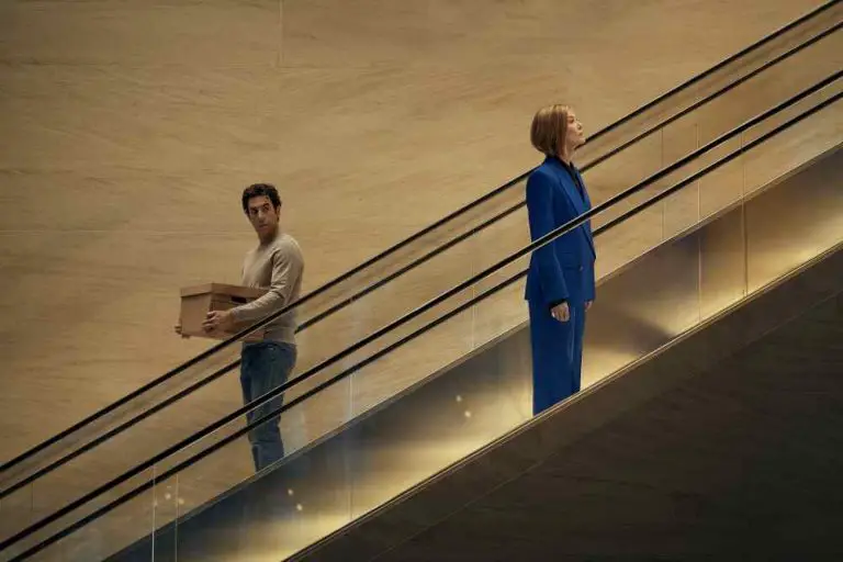 Ladies First. (L-R) Sacha Baron Cohen as Damien Sachs and Rosamund Pike as Alex Fox in Ladies First. Cr. Rob Youngson/Netflix © 2026.